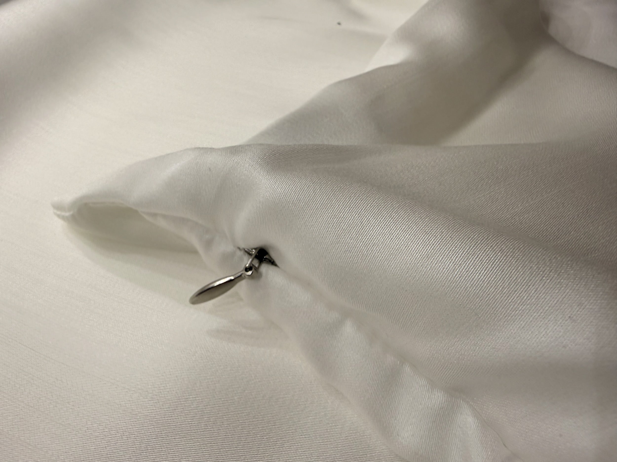 Nordhavn Living Aurora Satin Bettwäsche in Weiß (Quiet White): Detailbild des langlebigen Premium-Reißverschlusses, der dezent unter einer Stoffleiste verschwindet.